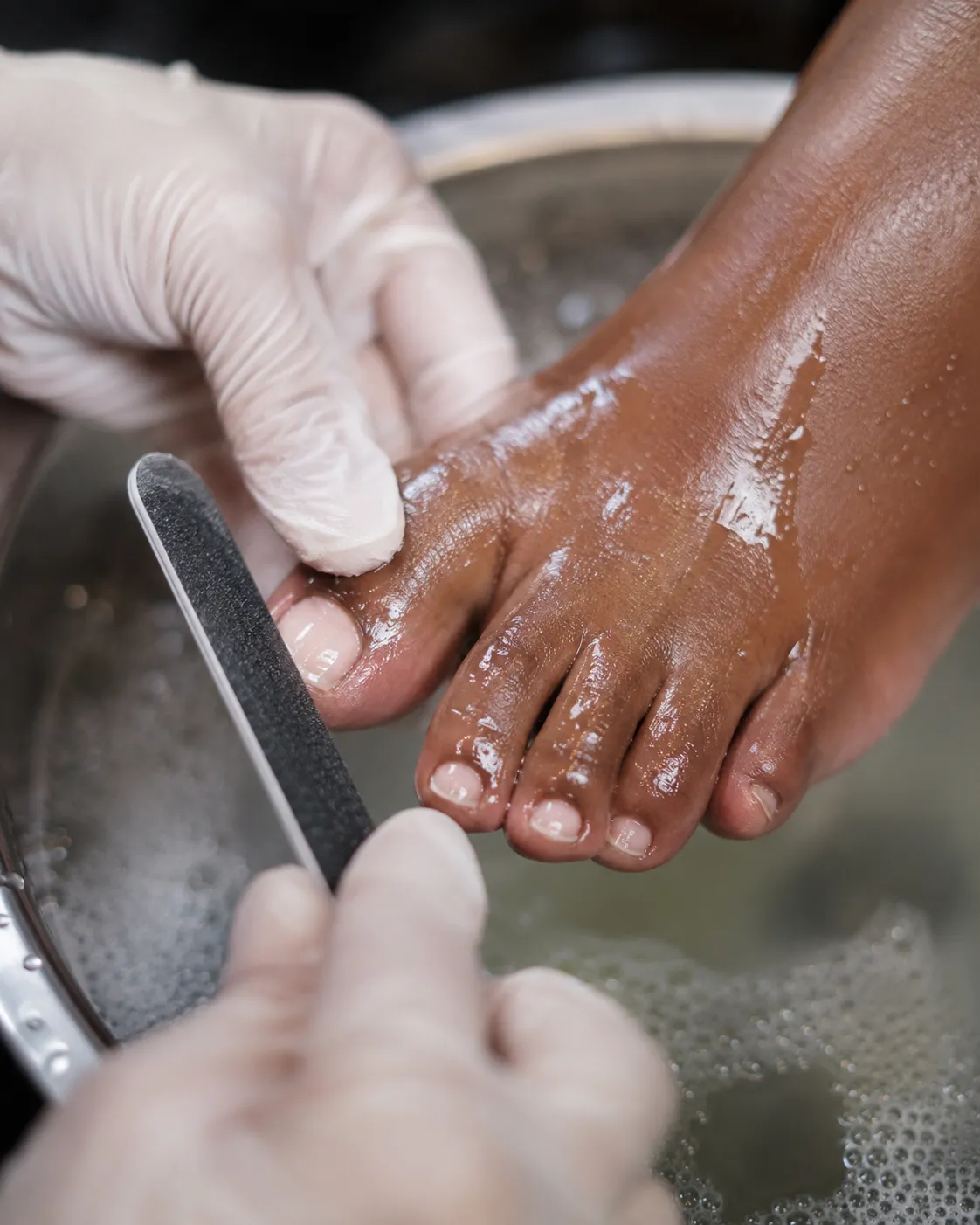 Pedicure in a foot spa bowl